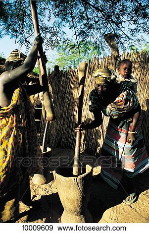 Senegal, Women crushing millet View Large Photo Image Stock Photo - Senegal, Women crushing millet. Fotosearch