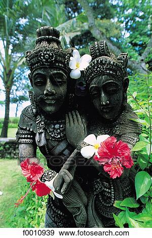 Garden statue decked with hibiscus View Large Photo Image Stock Photo - Garden statue decked with hibiscus. Fotosearch