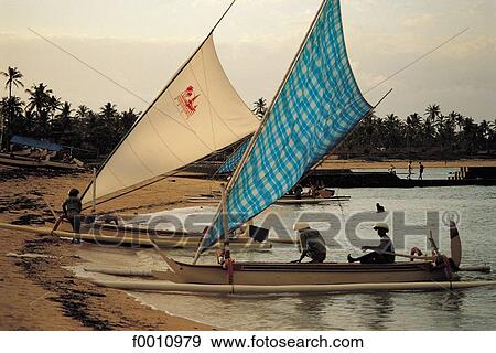 Stock Photo - Nusa Dua, fishermen returning at dusk. Fotosearch