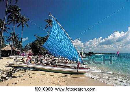 Stock Image - Outriggers on Nusa Dua beach. Fotosearch