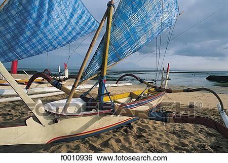 Stock Photograph - Outriggers on Nusa Dua beach. Fotosearch