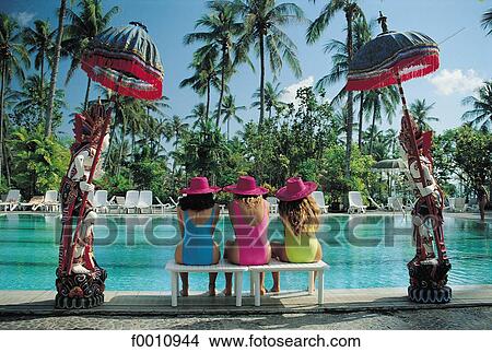 Three girls at a swimming pool View Large Photo Image Picture - Three girls at a swimming pool. Fotosearch