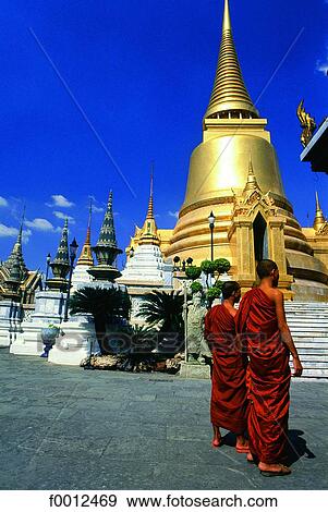 Thailand, Bangkok, Wat Phra Keo (Grand Palace), monks in front of a golden chedi View Large Photo Image Stock Photo - Thailand, Bangkok, Wat Phra Keo (Grand Palace), monks in front of a golden chedi. Fotosearch
