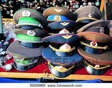 Stock Photo - Berlin, old Russian and East Germany caps to sell. Fotosearch