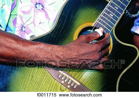 Stock Photography - Domenican Republic, Las Terranas, playing guitar on beach. Fotosearch