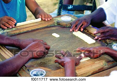 Stock Photo - Domenican Republic, Sanchez, men playing dominos. Fotosearch