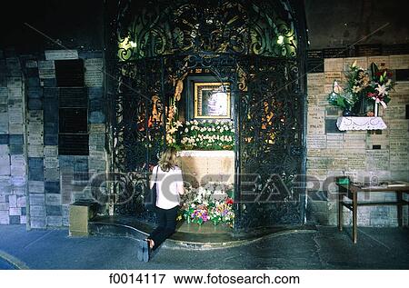 Stock Photo - Zagreb, praying at the Unburnt Icône Sanctuary. Fotosearch