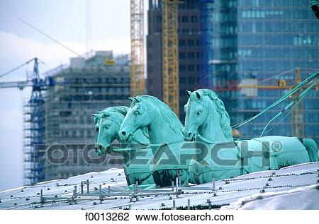 Stock Image - Brandenburg gate, the quadrige at works. Fotosearch
