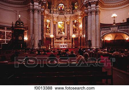 Stock Photo - Interior of the cathedral during a mass. Fotosearch
