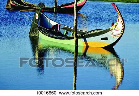 Stock Image - Portugal, near Aveiro, "Moliceiro" boat in a laguna. Fotosearch