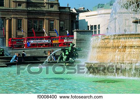 Stock Image - London, Trafalgar Square, fountain in summer. Fotosearch