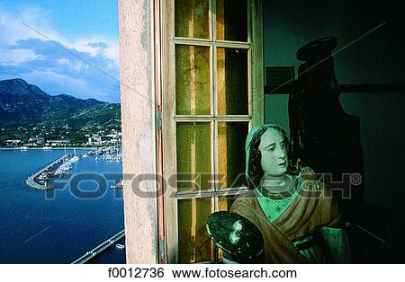 Stock Photograph - Corsica, Calvi, St Antoine oratory, baroque wooden statue and harbour. Fotosearch