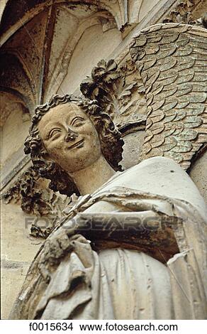 Picture - France, Champagne region, Reims, sculptures of the Gothic cathedral, famous smiling angel. Fotosearch