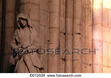 Stock Photo - France, Champagne region, Troyes cathedral, light from the stained glass and Virgin statue. Fotosearch