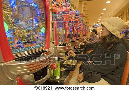 Stock Image - Japan, Tokyo, playing "Pachinko" slot machines. Fotosearch
