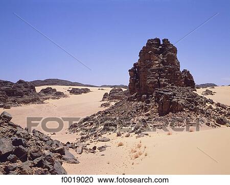 Stock Image - Algeria, Tassili n'Ajjer, sand dunes and rocks. Fotosearch