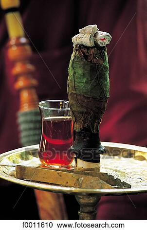 Stock Image - Turkey, Istanbul, Close-up on a waterpipe and tea glass. Fotosearch