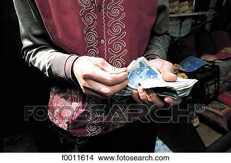 Turkey, Istanbul, Grand Bazaar, merchant counting his money View Large Photo Image Picture - Turkey, Istanbul, Grand Bazaar, merchant counting his money. Fotosearch