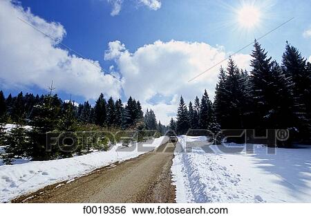Stock Photograph - France, Franche Comté, Jura mountains, snowy road. Fotosearch
