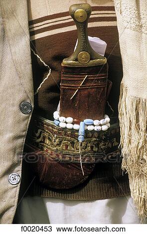 Stock Image - Yemen, traditional Jambiya daggar and beads. Fotosearch