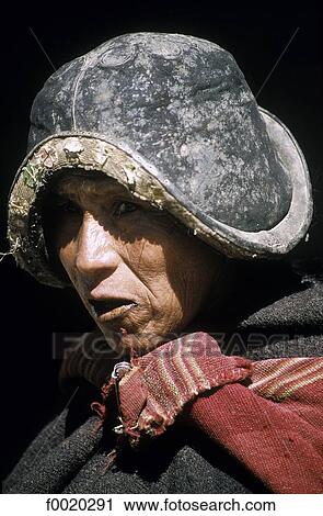 Stock Image - Bolivia, Tarabuco, indian woman bearing a Modera, inspired by the Conquistadores helmet. Fotosearch