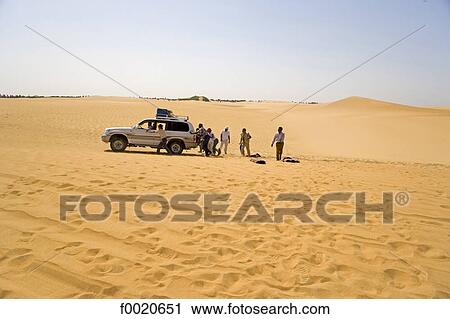 Stock Image - Sudan, Eastern Sahara, Bayuda desert, car getting suck in sand dunes. Fotosearch