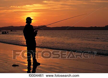 Stock Image - Channel Islands, Guernsey, fishing at sunset. Fotosearch