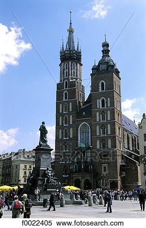 Stock Photography - Poland, Kracow, market place, Adam Mickiewicz Monument and Notre Dame Church. Fotosearch