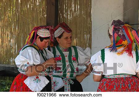 Stock Photograph - Hungary, Hollokö, women wearing traditional costumes. Fotosearch