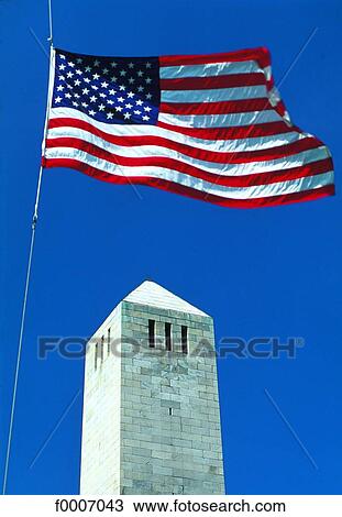 Stock Image - Louisiana, New Orleans, obelisk and American flag. Fotosearch