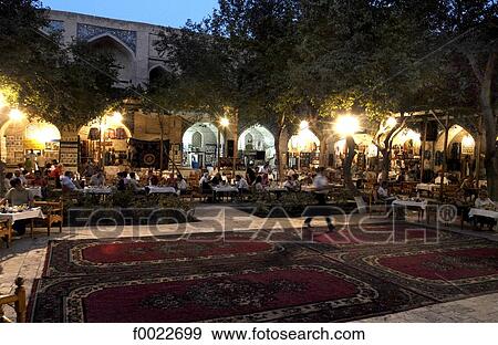 Stock Photo - Uzbekistan, Bukhara, Nadir Divanbegi Madrasah by night, old caravanserai. Fotosearch