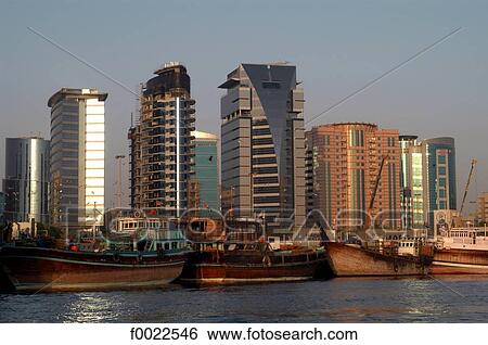 Stock Photograph - United Arab Emirates, Dubai, Creek Port, skyscrapers and dhows. Fotosearch
