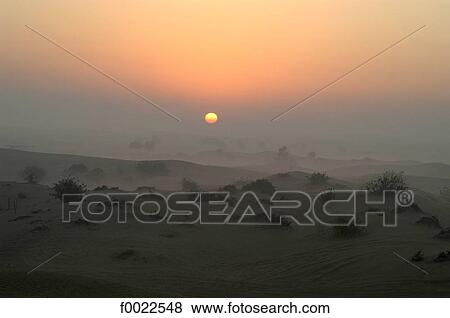 Stock Photo - United Arab Emirates, Dubai, sunrise on desert. Fotosearch