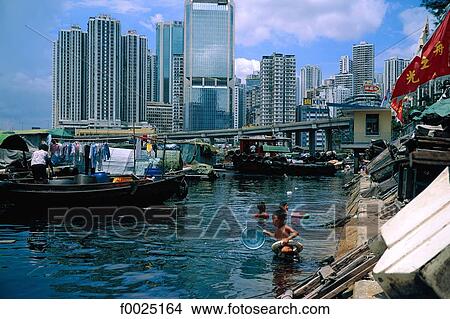 China, Hong Kong, shoreline in Wan Chai district, children bathing in polluted waters View Large Photo Image Picture - China, Hong Kong, shoreline in Wan Chai district, children bathing in polluted waters. Fotosearch