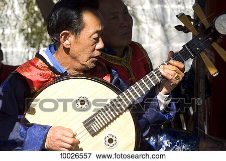 China, Yunnan, Dali, Bai man playing the shamisen View Large Photo Image Stock Photo - China, Yunnan, Dali, Bai man playing the shamisen. Fotosearch