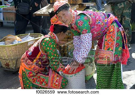 China, Yunnan, Dali, Bai women wearing traditional costume View Large Photo Image Stock Photo - China, Yunnan, Dali, Bai women wearing traditional costume. Fotosearch