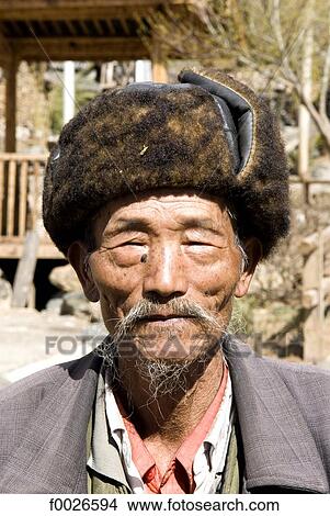 Picture - China, Yunnan, Lijiang, Naxi man portrait. Fotosearch