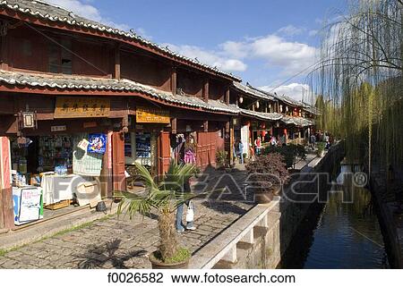 China, Yunnan, Lijiang, souvenir shops along a canal View Large Photo Image Stock Image - China, Yunnan, Lijiang, souvenir shops along a canal. Fotosearch