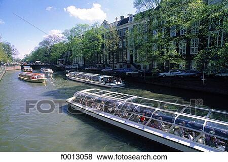 The Netherlands, North Holland, Amsterdam, several bateau mouche on a canal View Large Photo Image Stock Photo - The Netherlands, North Holland, Amsterdam, several bateau mouche on a canal. Fotosearch