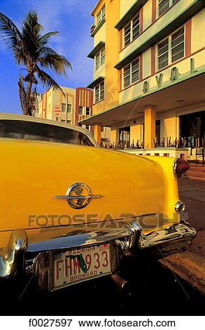 Stock Photo - United States, Florida, Miami Beach, classic car by Art Deco buildings. Fotosearch