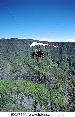 Stock Image - Reunion, Mafate cirque, ultralight flying. Fotosearch