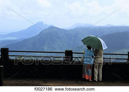 Mauritius, couple enjoying a scenic view on the mountains View Large Photo Image Stock Photograph - Mauritius, couple enjoying a scenic view on the mountains. Fotosearch