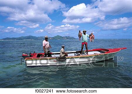 Stock Image - Seychelles, La Digue, fishermen. Fotosearch