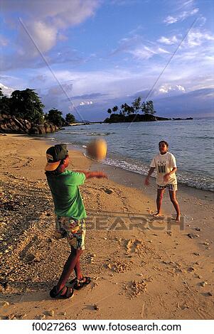 Seychelles, Mahé, children playing on the beach View Large Photo Image Stock Image - Seychelles, Mahé, children playing on the beach. Fotosearch