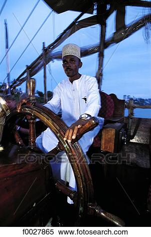 Kenya, Mombasa, men at the helm of a dhow View Large Photo Image Stock Photography - Kenya, Mombasa, men at the helm of a dhow. Fotosearch