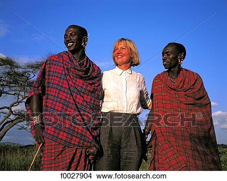 Tanzania, Manyara Region, young Maasai whith a blond woman View Large Photo Image Picture - Tanzania, Manyara Region, young Maasai whith a blond woman. Fotosearch