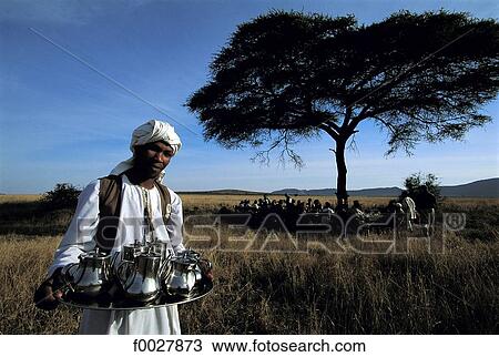 Stock Image - Tanzania, Serengeti National Park, plein-air breakfast, waiter. Fotosearch