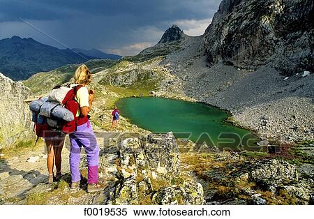 Stock Photography - France, Alps, la Clarée Lake, hikers. Fotosearch