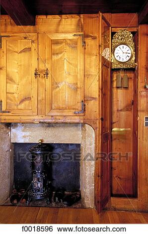 Stock Photograph - France, Franche-Comté, traditonal inside whith grandfatherclock. Fotosearch