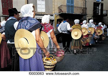 Stock Image - France, Provence, Valensole, men and women wearing the traditional Provencal costume. Fotosearch